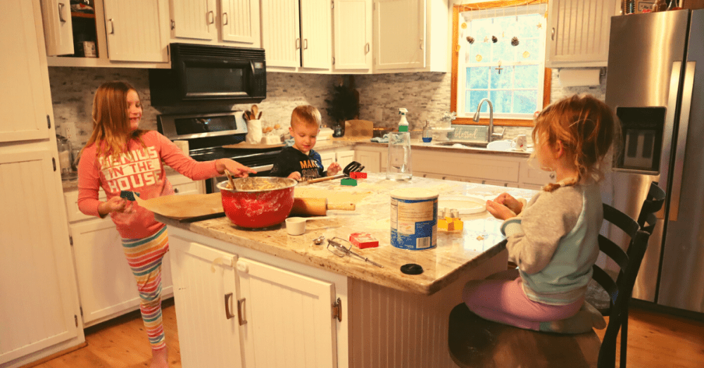 kids at kitchen counter making cookies